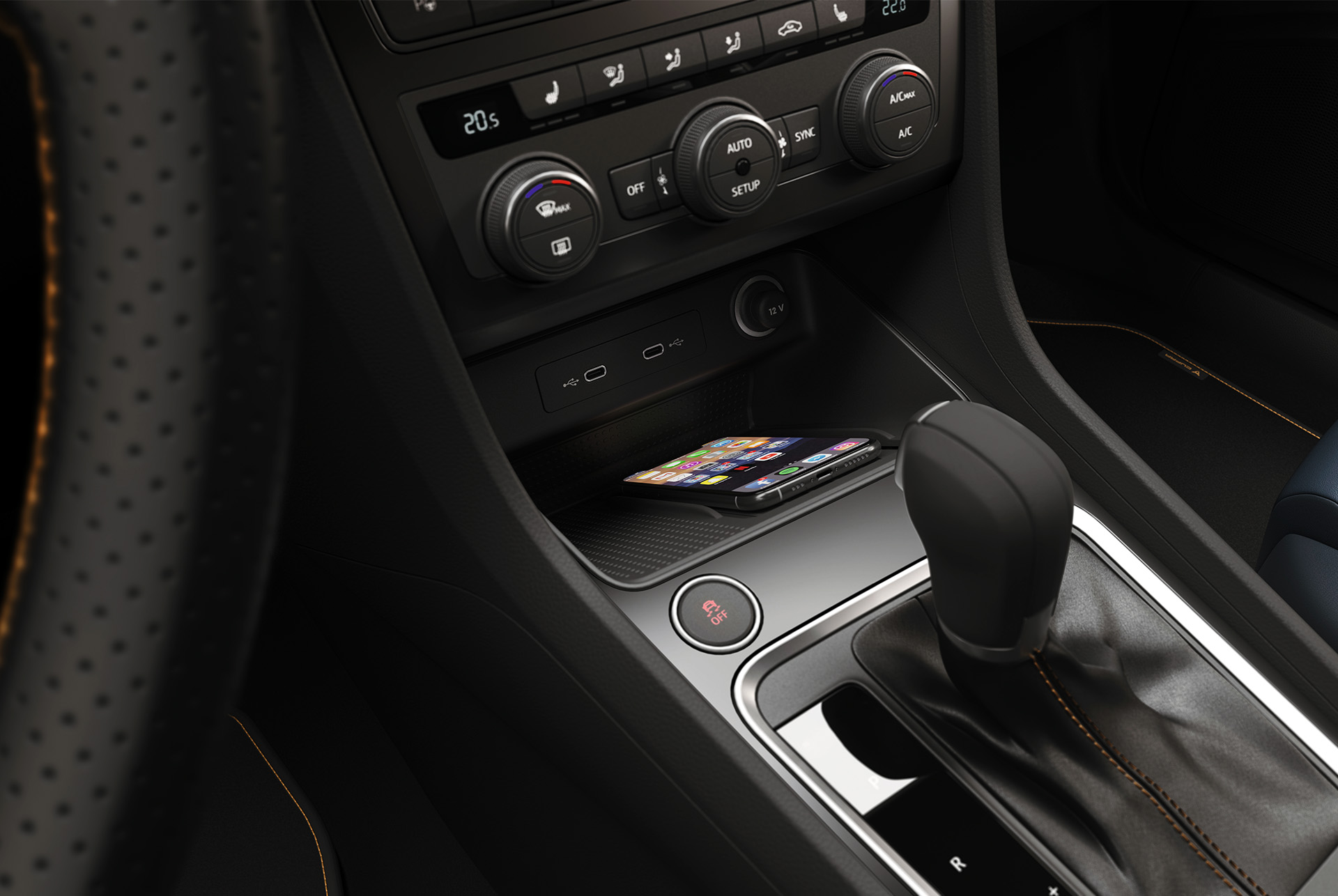 The CUPRA Ateca's Connectivity Box with wireless charging, displaying a smartphone placed on the charging pad near the gear shifter.