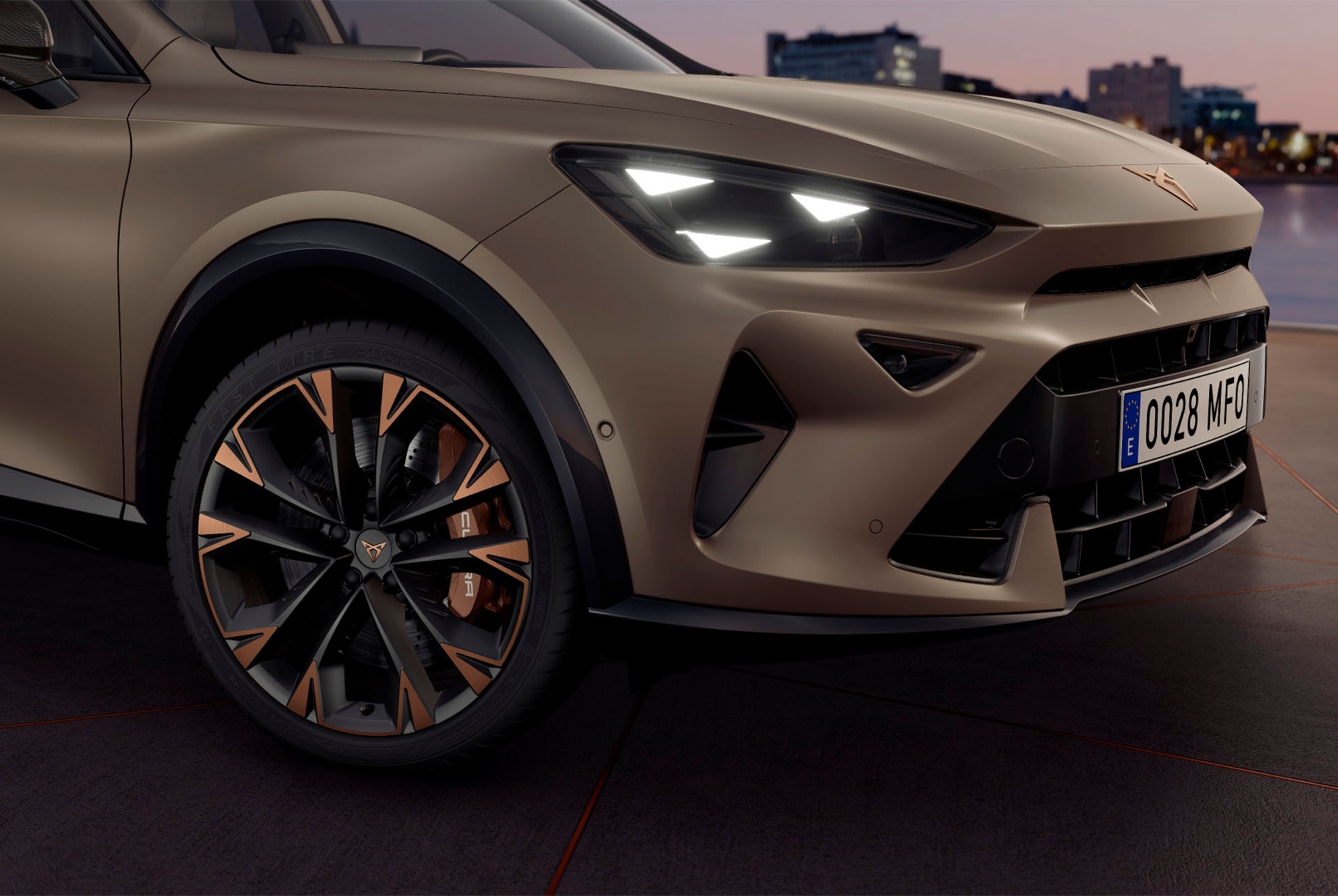 Exterior view of new CUPRA Formentor copper accent wheels, Akebono brakes, wing mirror, tyres, signature triangle eye LED headlights and CUPRA logo.