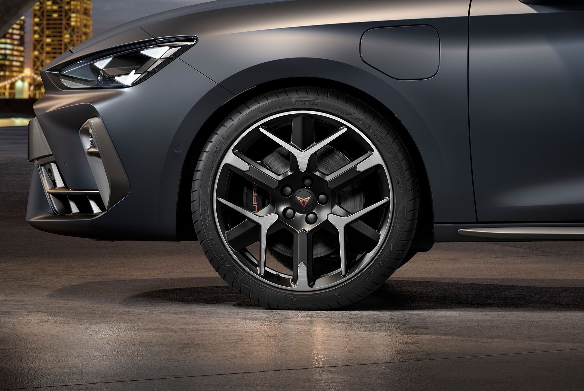 : front side view of left forged wheel in silver and black for the new cupra leon 2024, tyres, signature headlights and matt grey car body