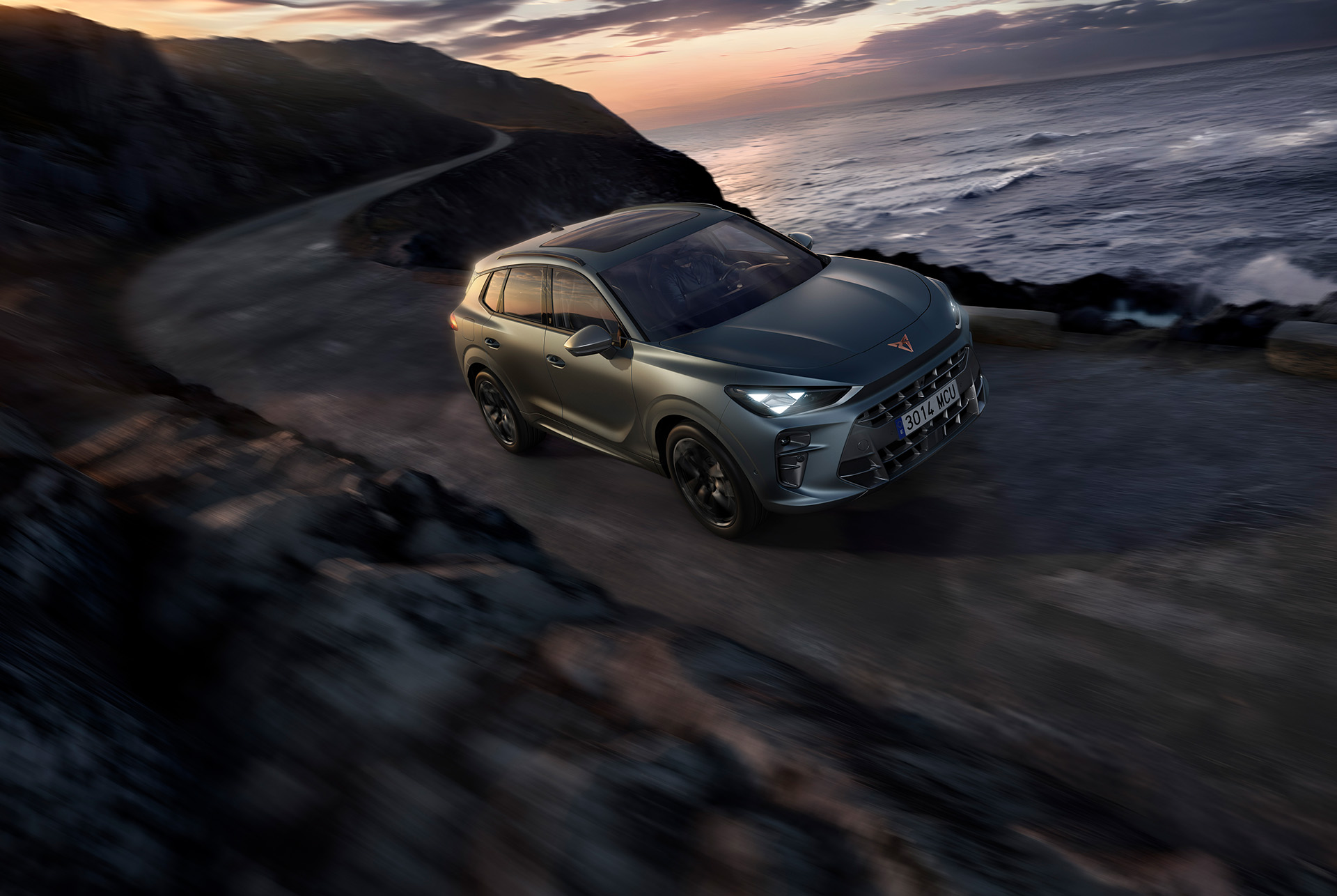 cupra terramar america’s cup exclusive version driving along a coastal road, featuring enceladus grey matt paint and 20 inch america’s cup alloy wheels.