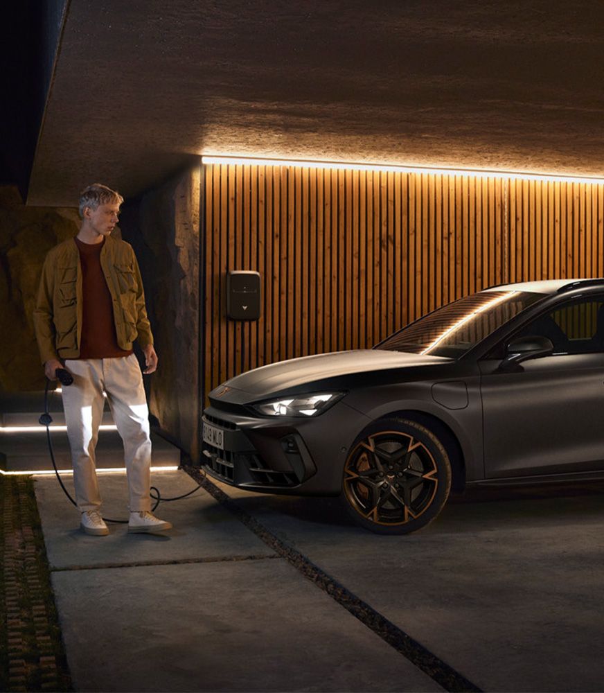 A%20cupra%20leon%20sportstourer%20e-hybrid%20car%20charging%20at%20home%20in%20a%20sleek,%20modern%20setting,%20featuring%20magnetic%20tech%20matte%20gray%20paint%20and%20exclusive%20machined%20aero%20sport%2019%20inch%20wheels.