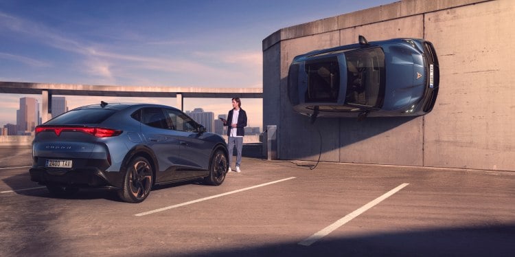 A cupra vehicle displayed in an urban parking setting, showcasing a vehicle fleet, the cupra tavascan and personal contact plan (pcp), offering tailored finance solutions for owning or leasing a cupra vehicle.