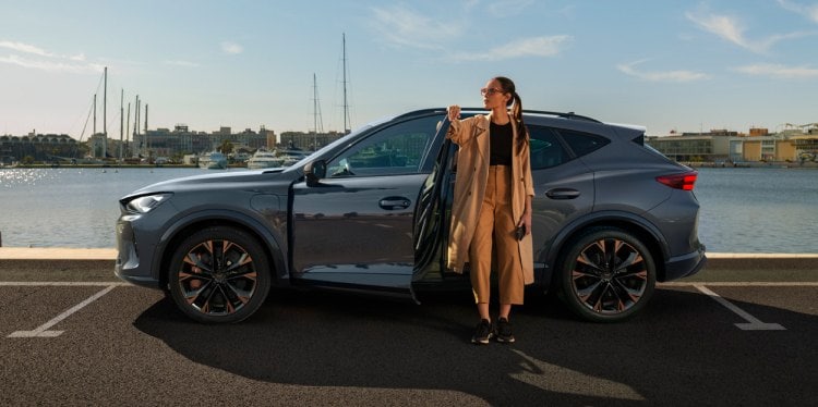 Woman exiting the cupra tavascan obtained through hire purchase leasing with no balloon payment.