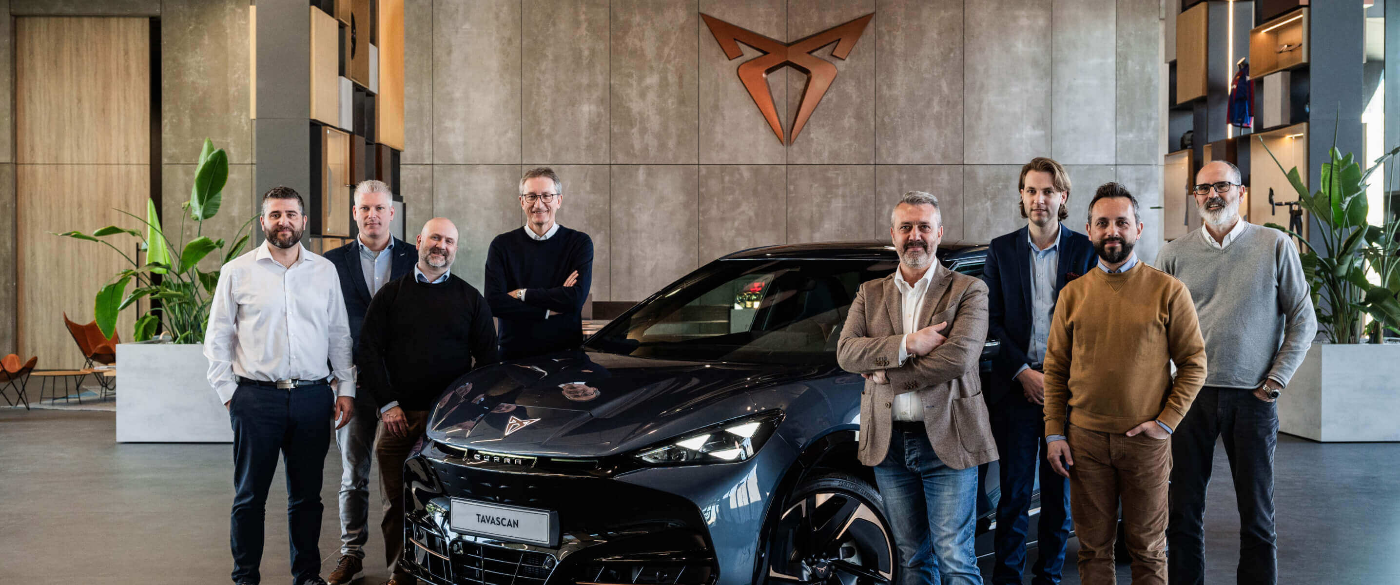 Cupra terramar vehicle inside as showroom with fleet managers, copper cupra logo on the wall.